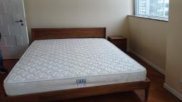 A wooden bed frame and a mattress image 1