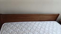 A wooden bed frame and a mattress image 3