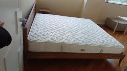 A wooden bed frame and a mattress image 4