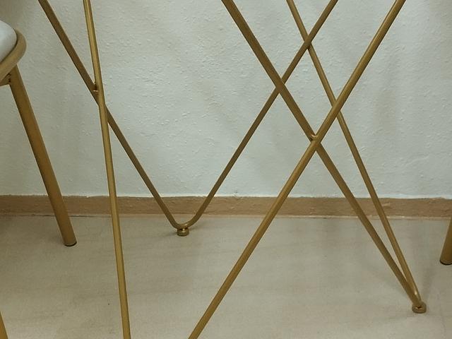 Gold-framed glass table and chairs