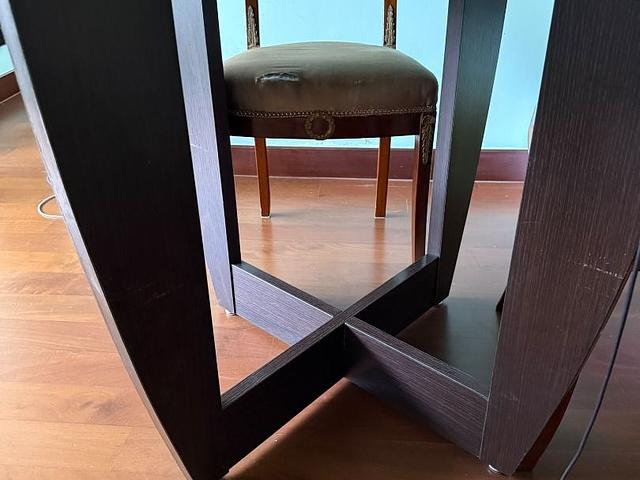 Round dark wood dining table with back glass top