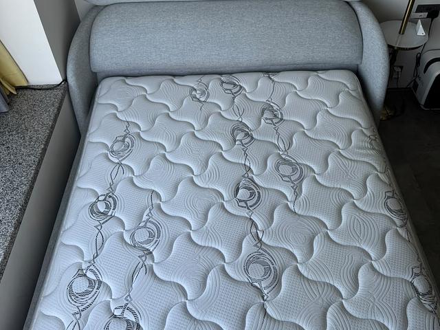 Grey upholstered bed with Simmons mattress