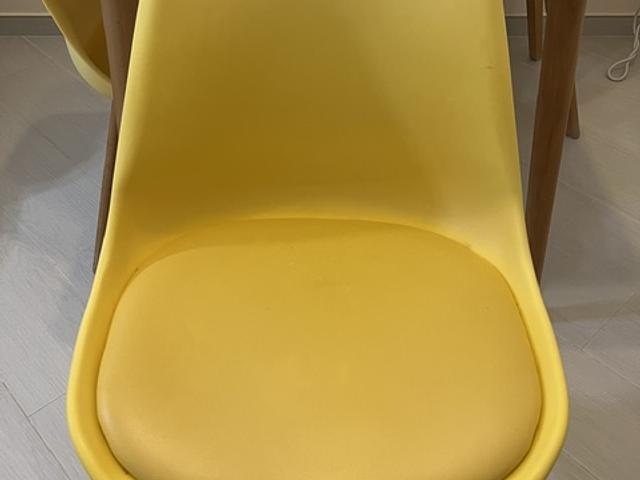 Well Used White dining table w/ four yellow chairs