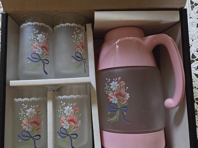 4 glasses with water jug